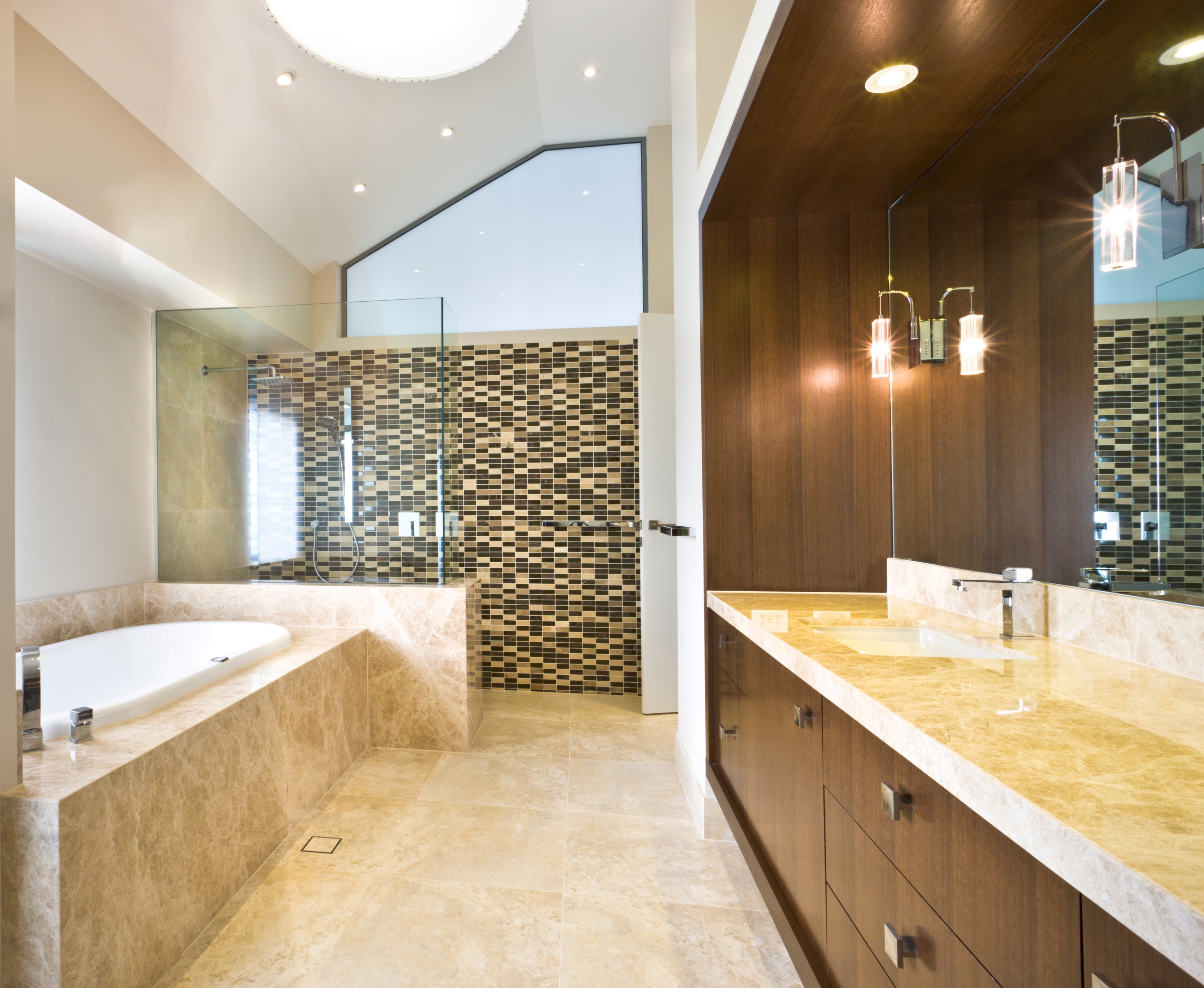 Modern bathroom with bathtub, glass shower, and wooden vanity